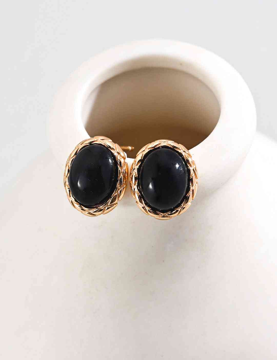 Gold Noir Elegance black agate stud earrings on display