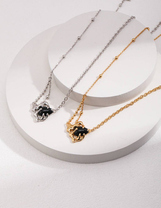 three different necklaces on a white plate