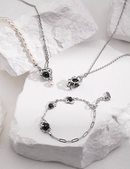 a set of silver chains with black agate stone