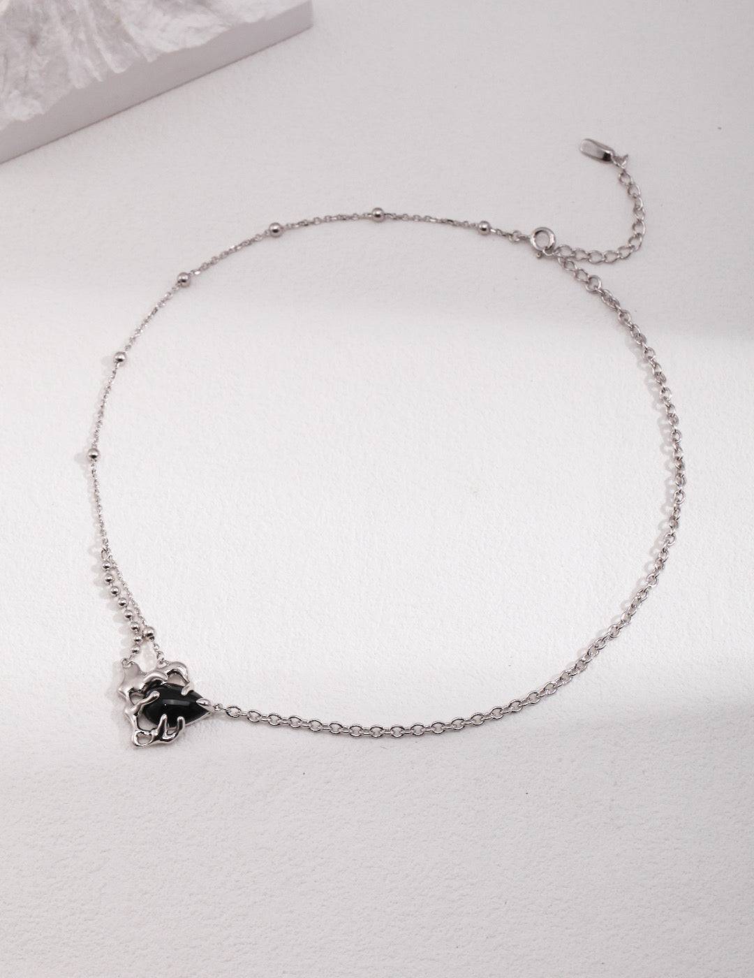 a silver chain bracelet with a flower charm