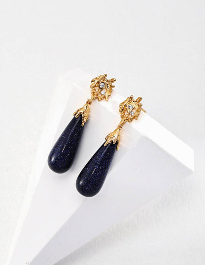 a pair of earrings on a napkin