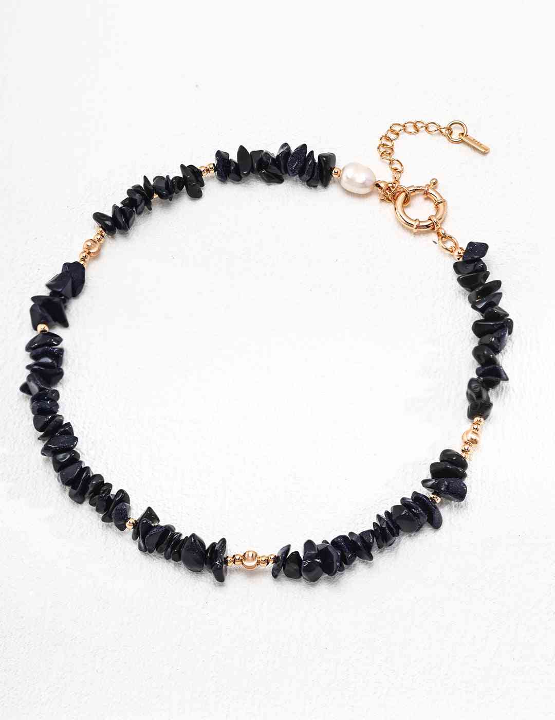 a blue sandstone beaded bracelet with a gold clasp