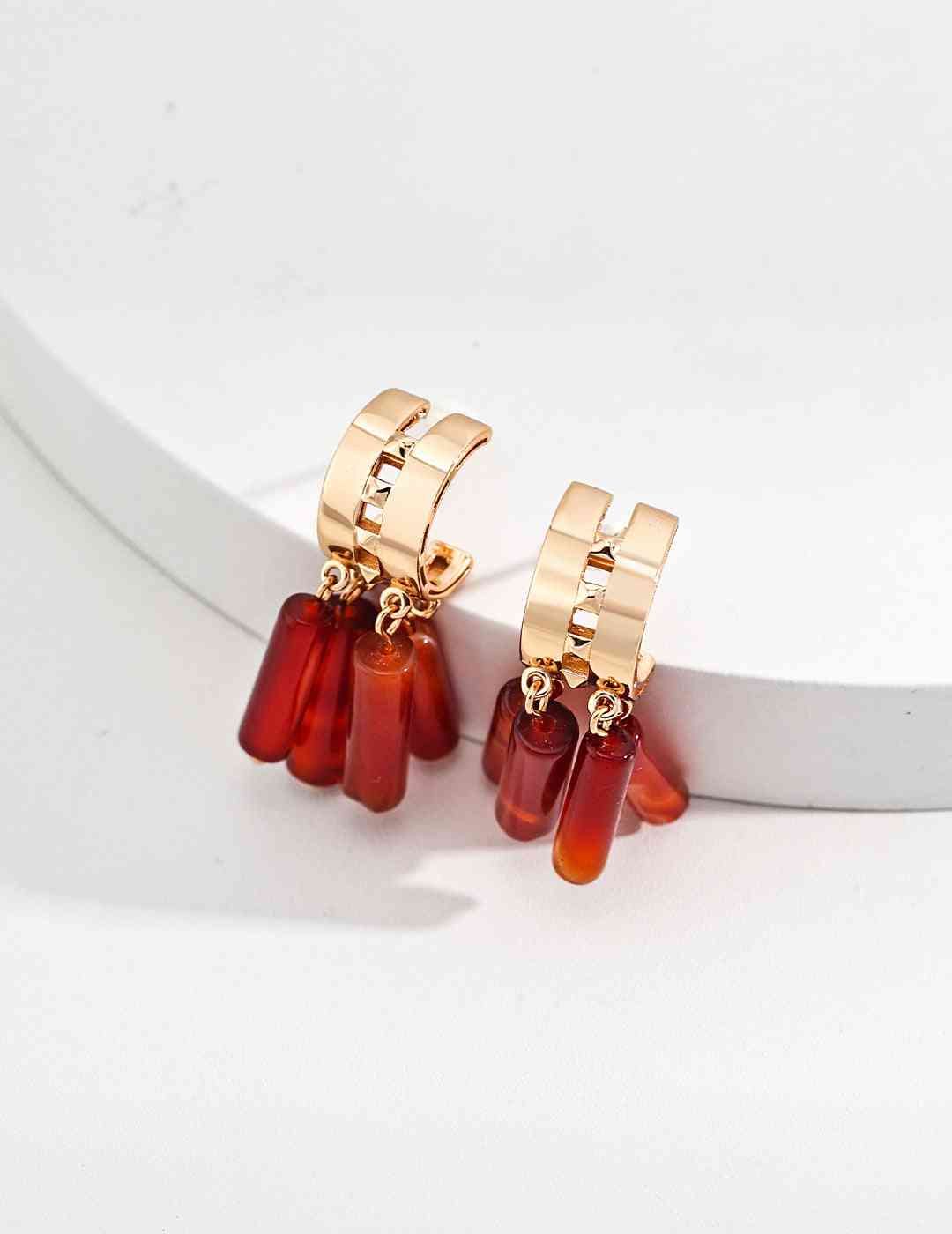 Sunset Glow Red Agate Dangle Earrings on display