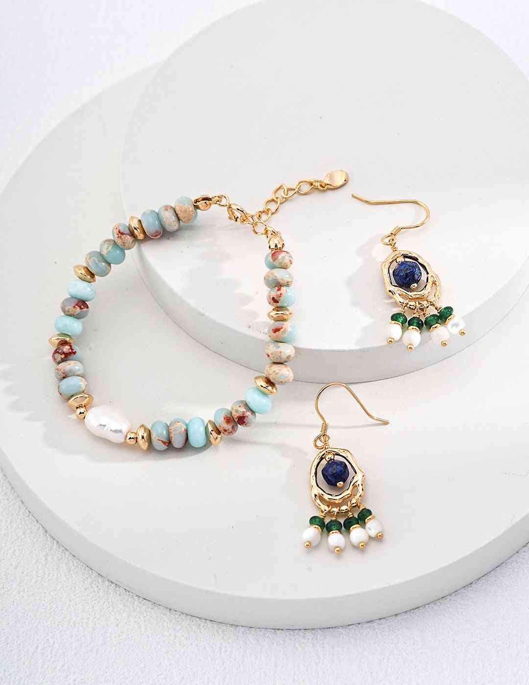 a pair of bracelets and earrings on a white plate