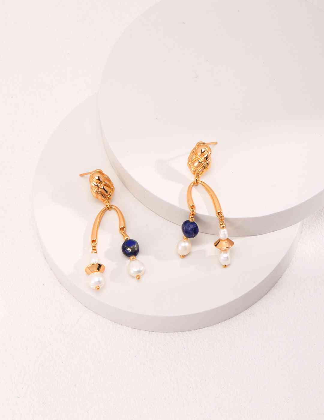 a pair of earrings on a white surface