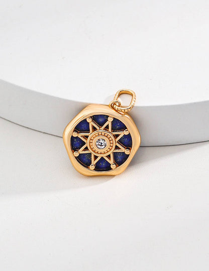 a gold plated pendant with a blue lapis lazuli stone in the center