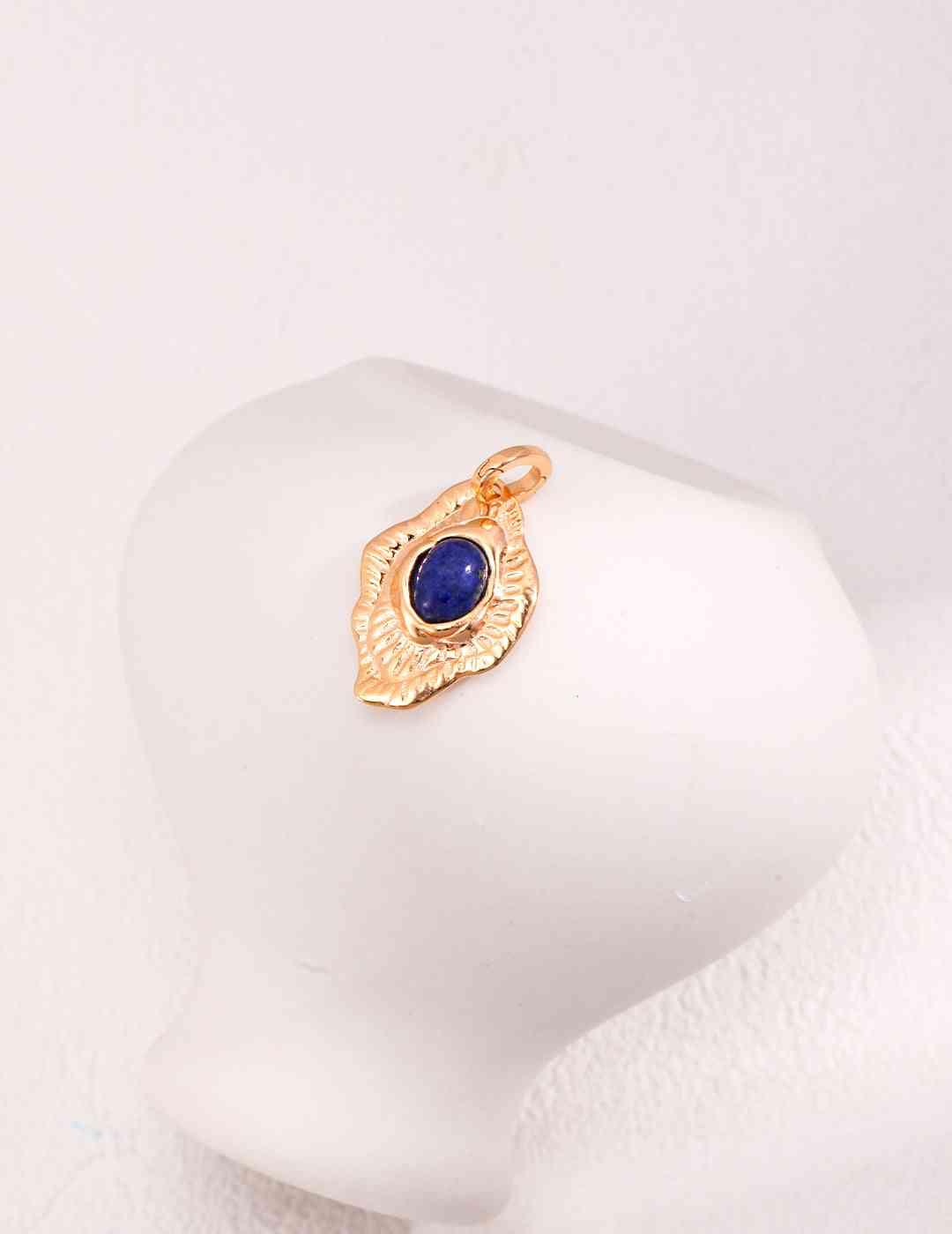 a gold ring with a blue stone in the middle