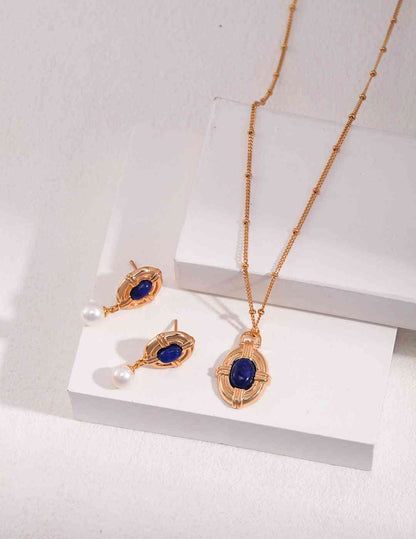 a necklace and earring set with a blue stone