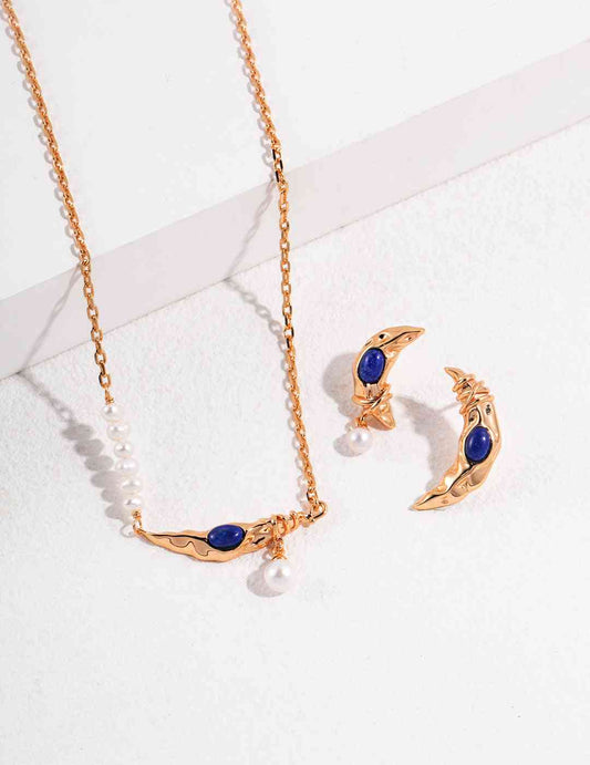 a necklace and earring set with blue lapis lazuli stones and white pearls