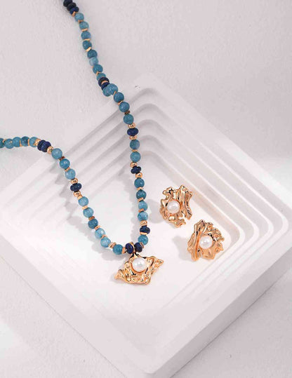 a amazonite necklace and earring set on a white tray