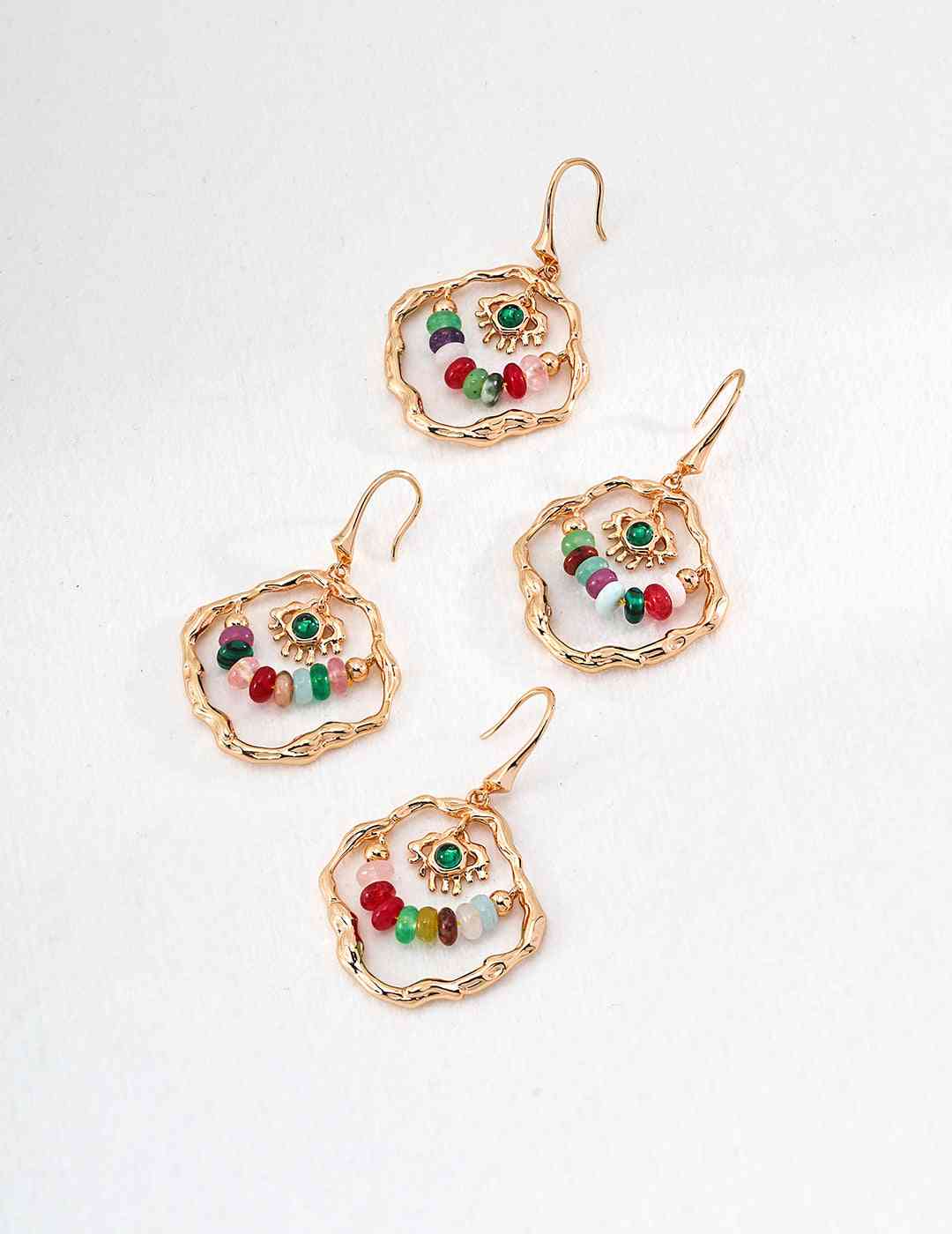 three pairs of earrings with beads on them