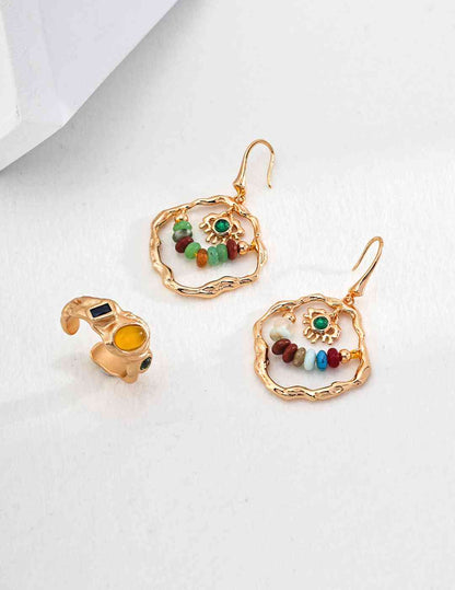 a pair of earrings with beads and charms