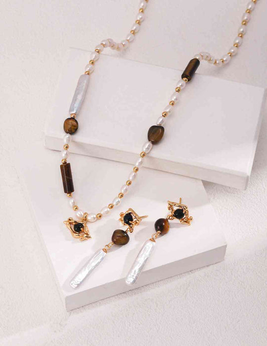 Tiger's eye necklaces and earrings on a white surface