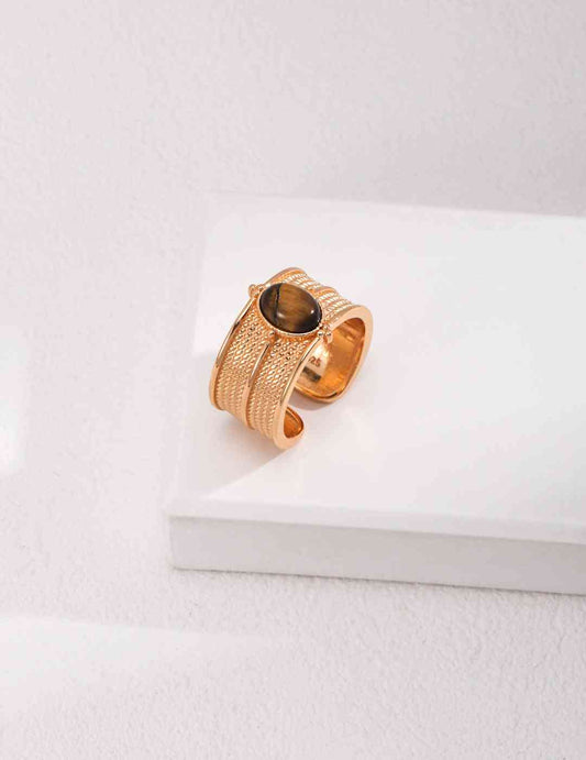 a gold ring sitting on top of a white surface