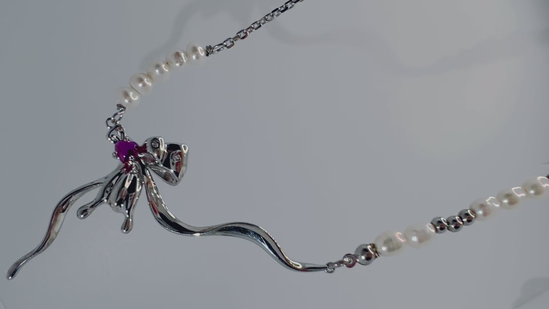 Close-up of spider pendant with purple zircon and pearls